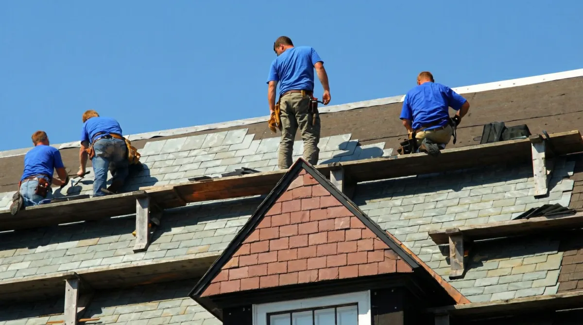 Roof replacement in progress with a team of professional contractors installing new shingles on a residential home in Chattanooga, TN